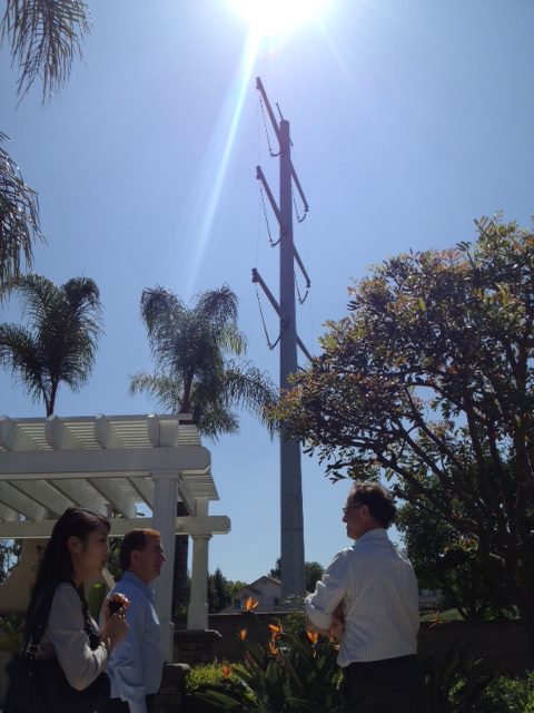 Officials looking up at 185-ft tower from a residential backyard in Chino Hills, CA